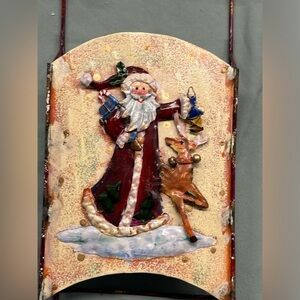 Adorable metal sled Santa decoration. Santa carries toys, a lantern and a friend
